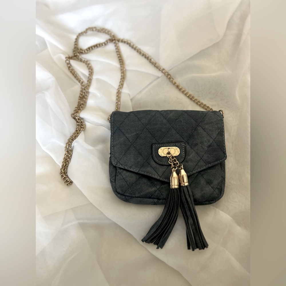 Swayed blue purse with gold colored chain.